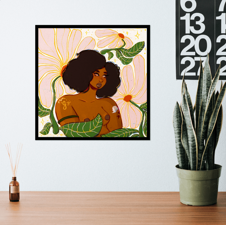 daisy nude illustration art print shown in a black square frame above a desk. on the desk is a potted snake plant and oil diffuser. a large wall calendar is shown in the corner of the white wall.