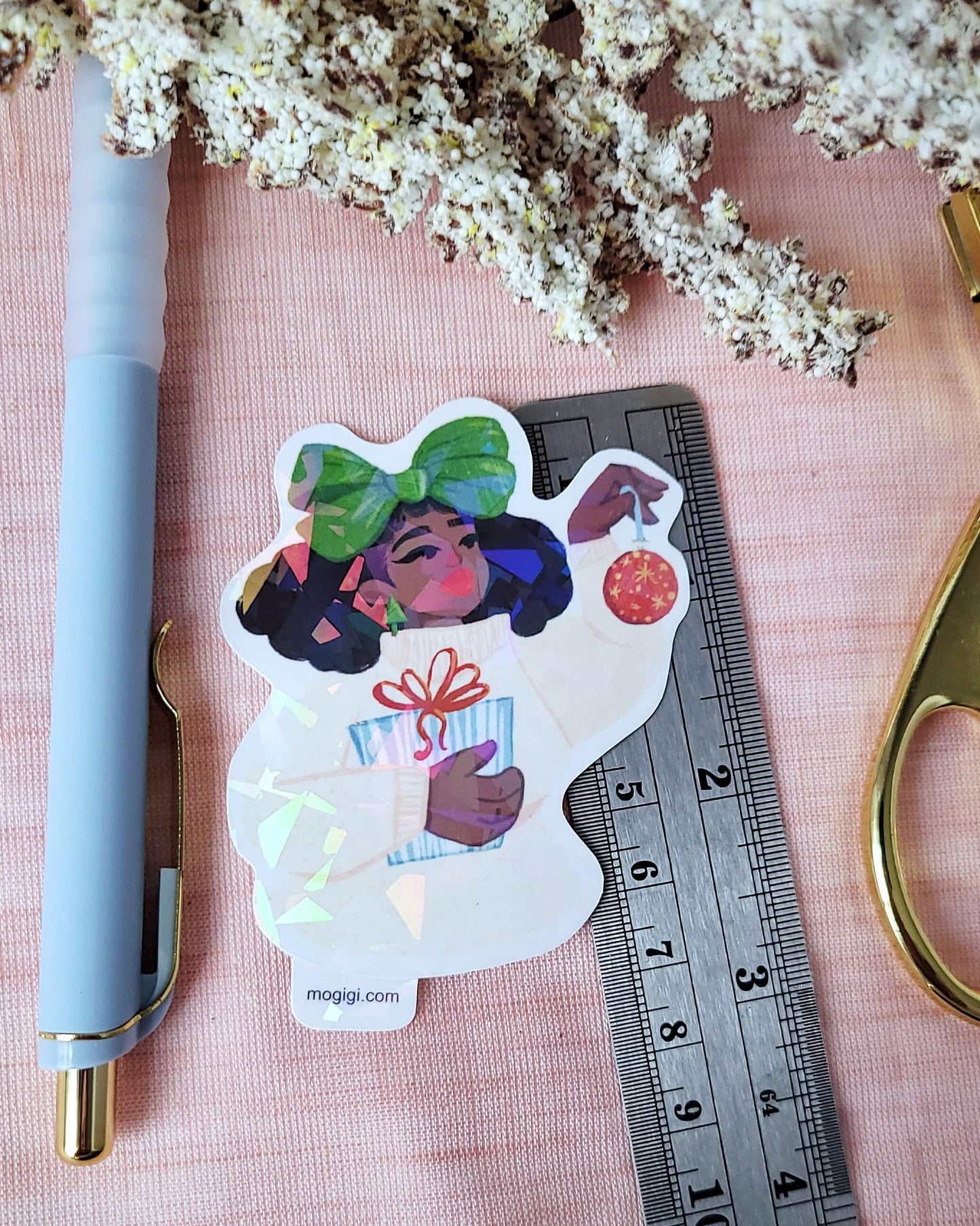 Christmas Bow Girl MoGigi™ and Elyse Mountains Ski Lodge Sticker Collaboration, black woman natural hair art, cozy winter sweater, festive decorations, presents, holographic waterproof die-cut vinyl sticker lovingly created by Virginia illustrator and designer Gigi Moore, black woman owned art shop, small business handmade gifts