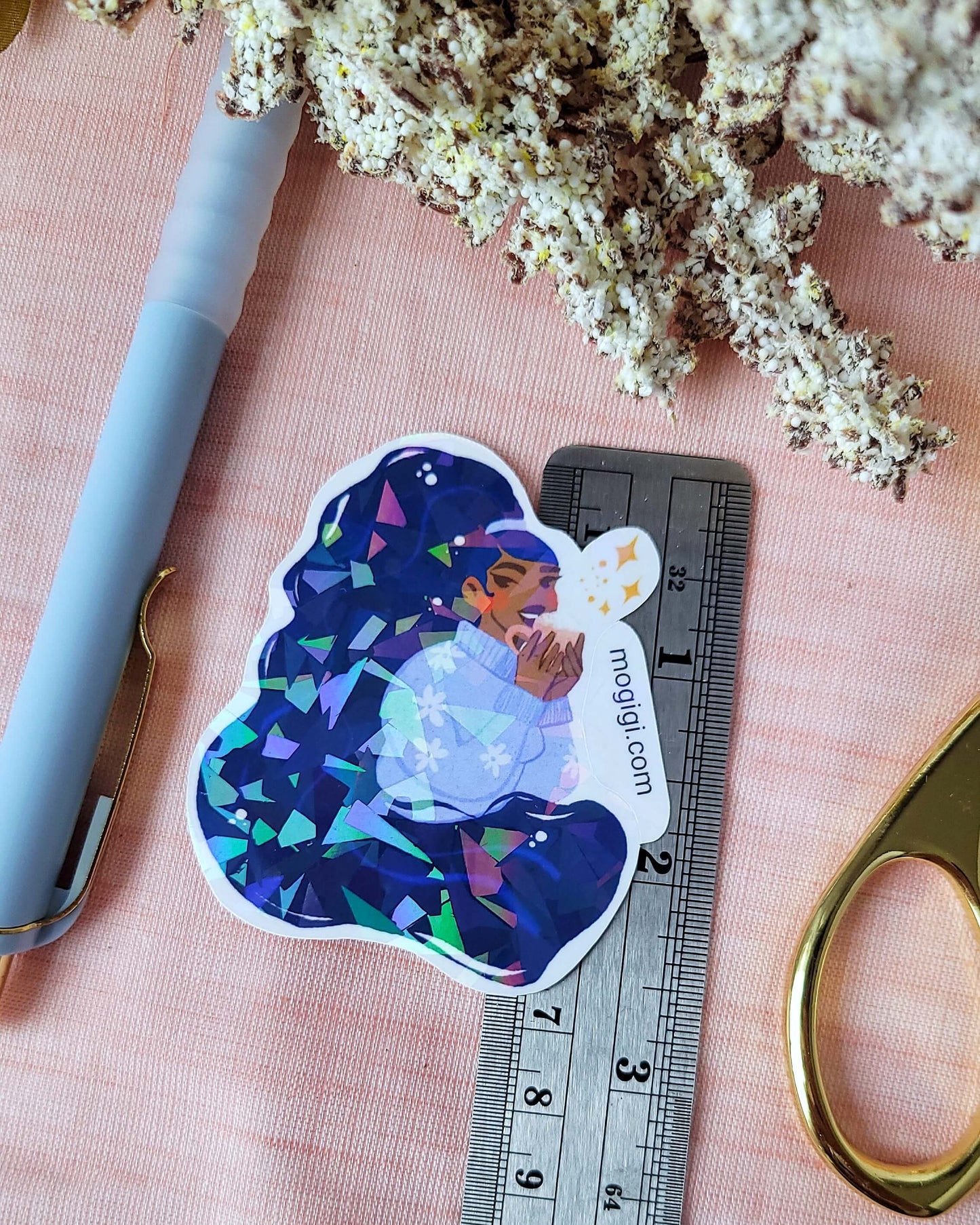 Tis The Season Girl Sticker, mogigi and elyse mountains ski lodge limited edition sticker collaboration, christmas holiday holographic waterproof custom unique illustrated decal by Virginia illustrator Gigi Moore. Shopify Art Shop MoGigi™, black woman art, cozy winter blue sweater, enchanting festive winter ski  cabin theme, broken glass laminated waterproof stickers