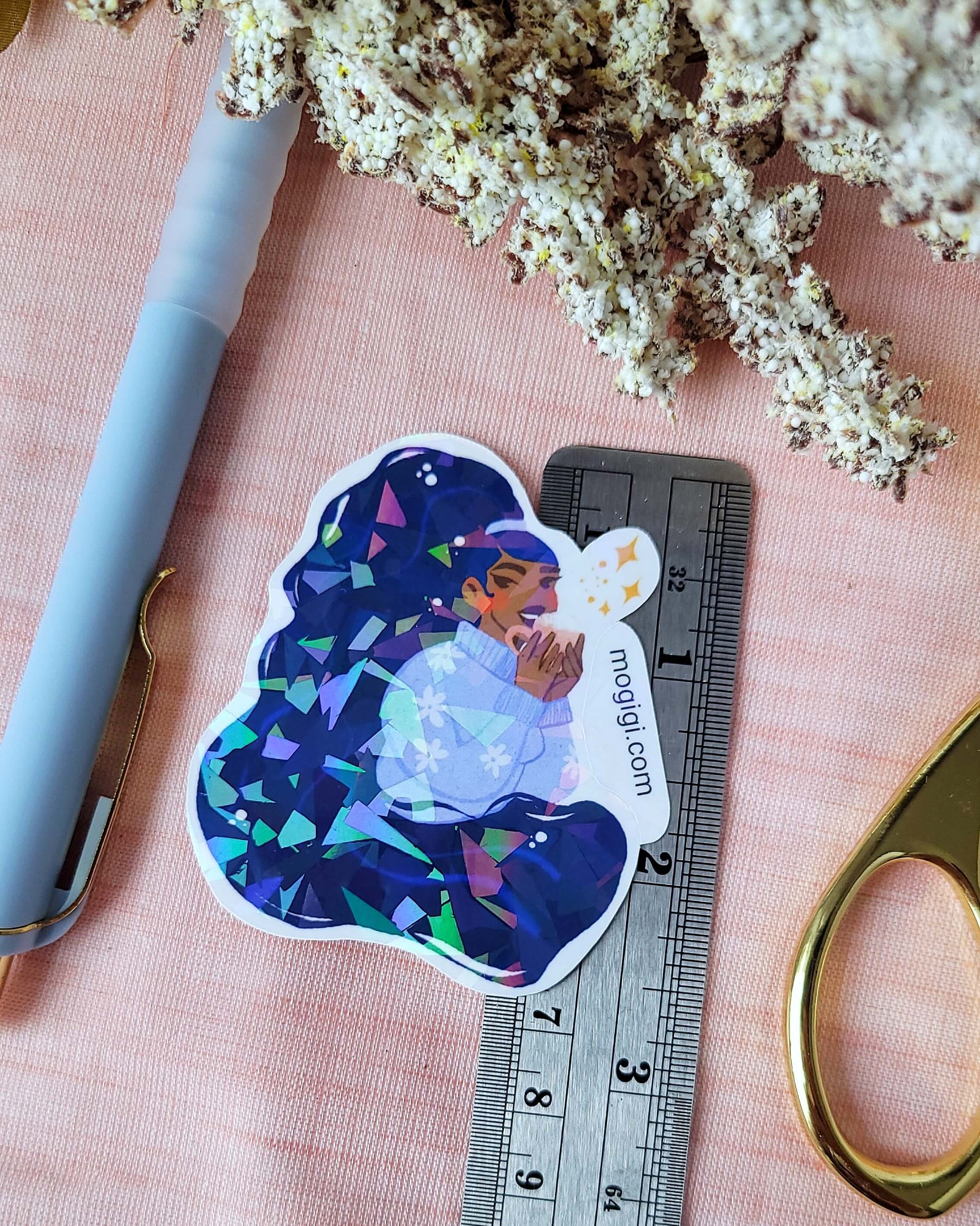 Tis The Season Girl Sticker, mogigi and elyse mountains ski lodge limited edition sticker collaboration, christmas holiday holographic waterproof custom unique illustrated decal by Virginia illustrator Gigi Moore. Shopify Art Shop MoGigi™, black woman art, cozy winter blue sweater, enchanting festive winter ski  cabin theme, broken glass laminated waterproof stickers